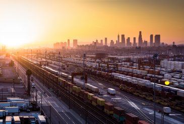 Intermodal Freight Yard with Los Angeles Skyline at Sunset