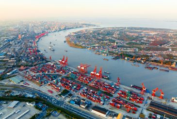 Top view of deep water port with cargo ship and containers in Shanghai.